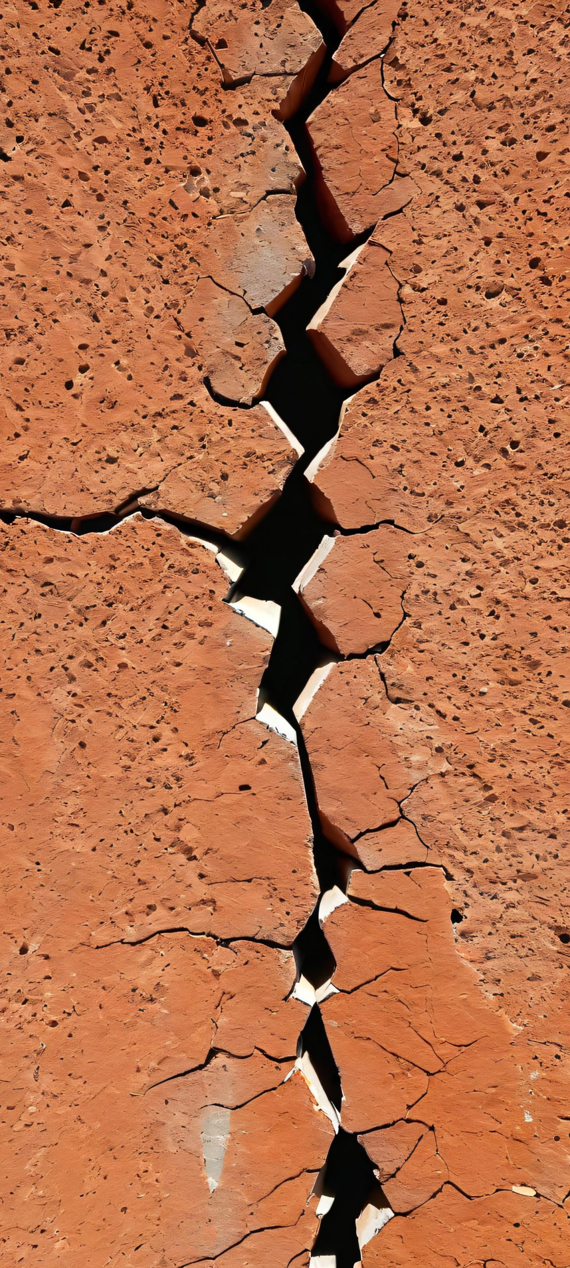 iPhone/Android wallpaper featuring a stunning vertical view of wall cracks in an abandoned urban setting, showcasing a masterpiece of harsh yet beautiful minimalism