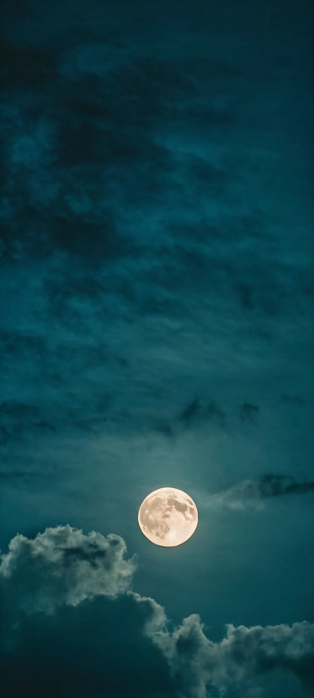 iPhone/Android mobile phone wallpaper featuring a stunning glowing moon against dark clouds with curepeach tones, perfect for home screens.