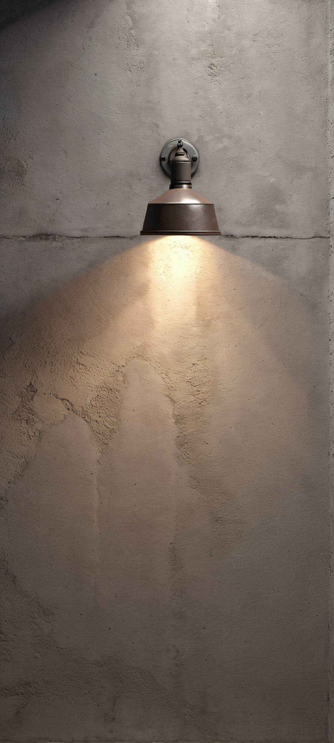 Industrial Oasis 2K QHD Home Screen Moody Industrial Corner wallpaper featuring a single spotlight in a warm gray and dark brown concrete room, perfect for iPhone/Android devices.