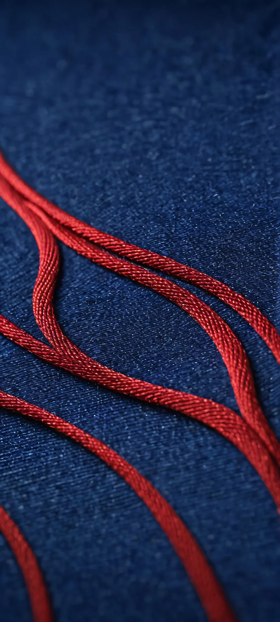 Macro of Malevola's dark denim fabric texture, perfectly suited for iPhone and Android home screens.