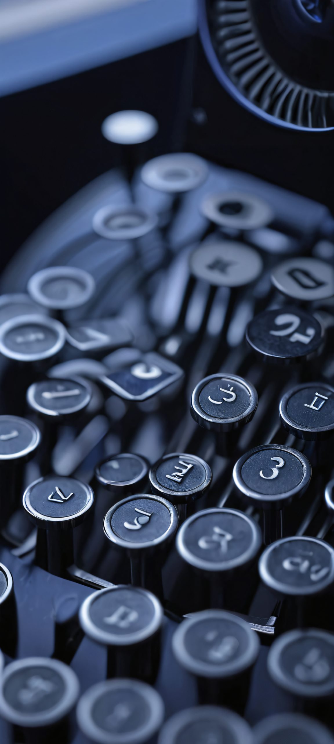 Midnight Typewriting 2K Phone Wallpaper A moody office scene at night, featuring a typewriter under warm desk lamps on an iPhone or Android device.