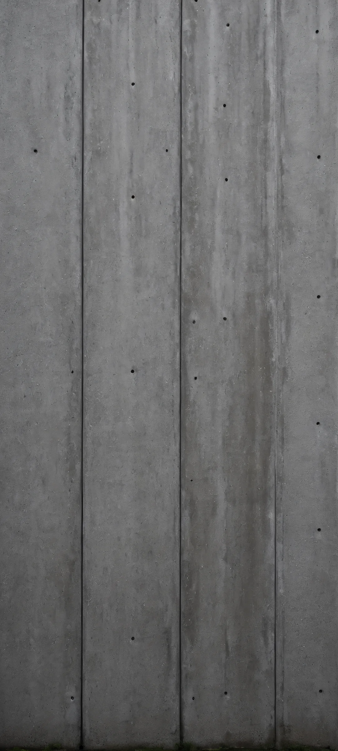 iPhone and Android phone wallpaper of a dark, minimalist concrete wall with moody texture. Perfect for home screens.