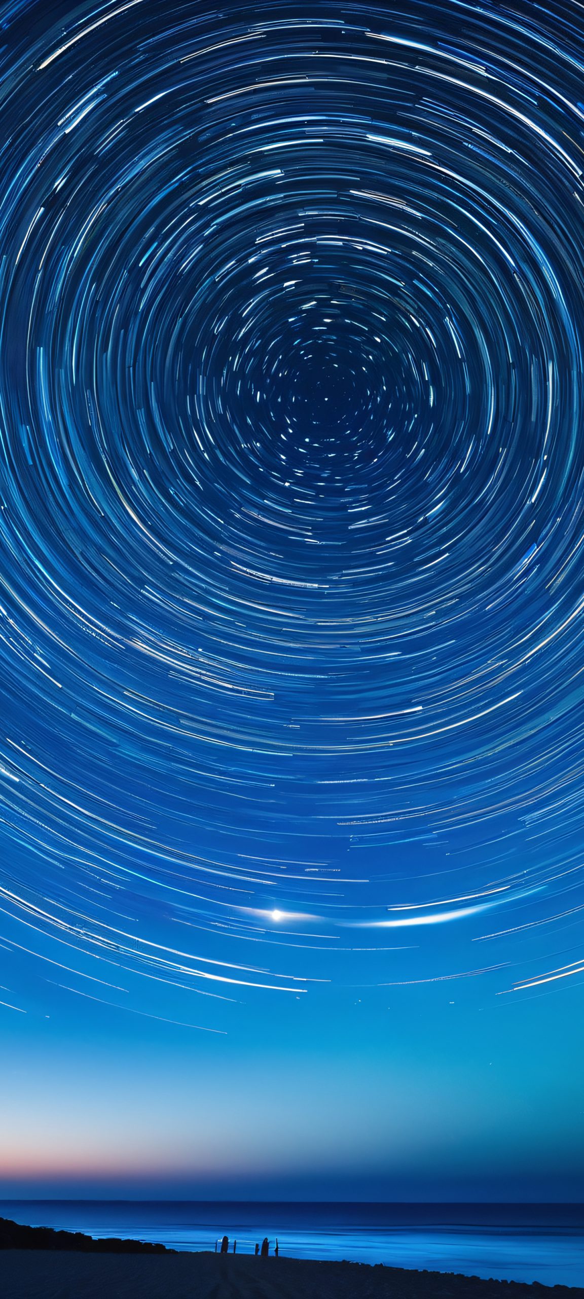 Gorgeous Star Trail above a calm ocean at night, perfectly suited for iPhone/Android home screens